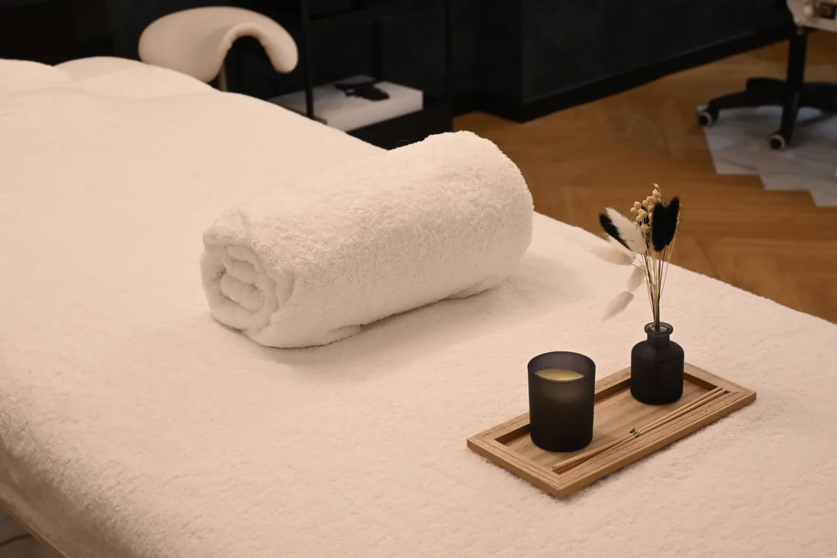 Quiet massage room with a prepared treatment table